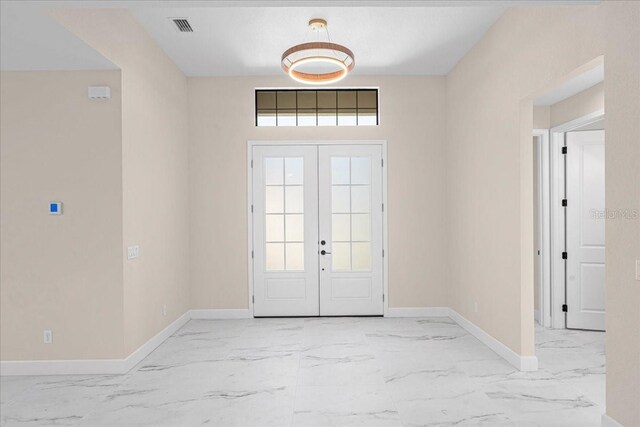 foyer entrance featuring french doors