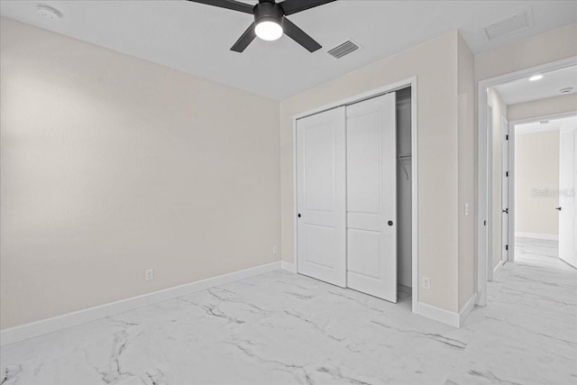 unfurnished bedroom with ceiling fan and a closet