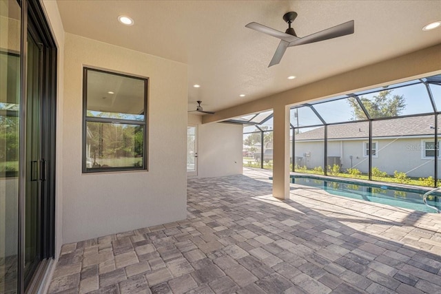 view of patio featuring glass enclosure