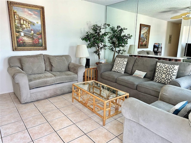 tiled living room featuring ceiling fan and a textured ceiling