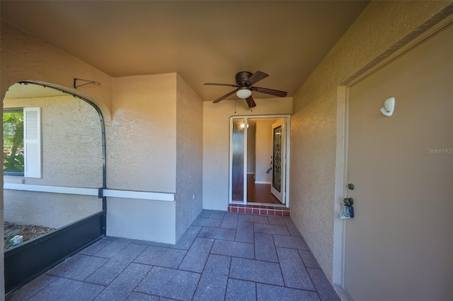 entrance to property with ceiling fan