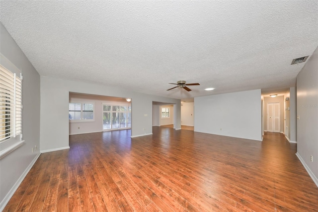 interior space with a textured ceiling, dark hardwood / wood-style floors, and ceiling fan