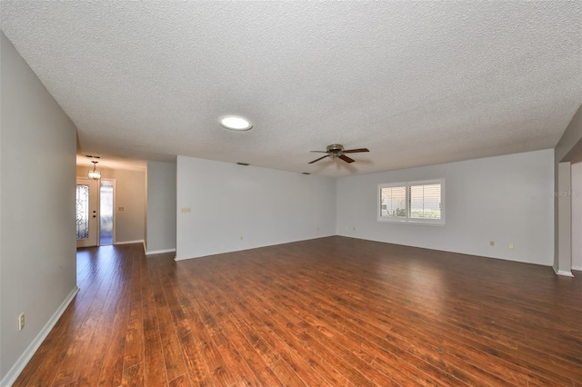 unfurnished room with a textured ceiling, ceiling fan, and dark wood-type flooring