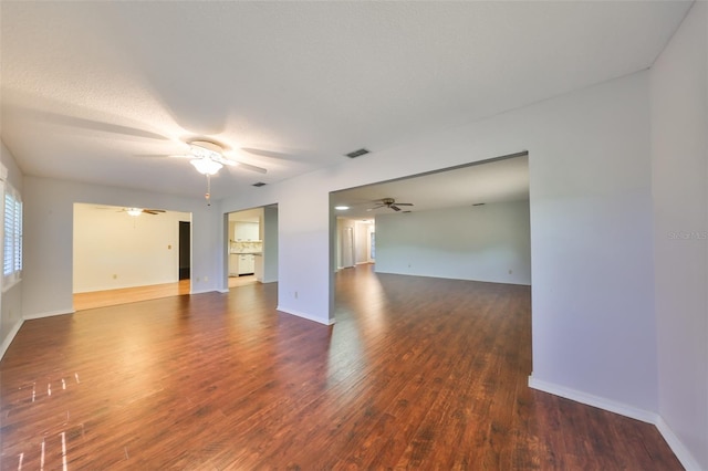 spare room with dark hardwood / wood-style floors and a textured ceiling