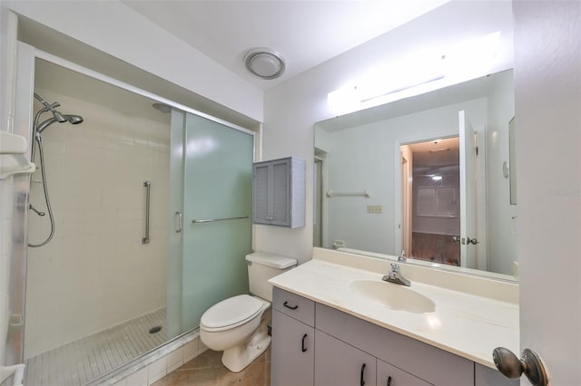 bathroom featuring tile patterned flooring, vanity, toilet, and an enclosed shower