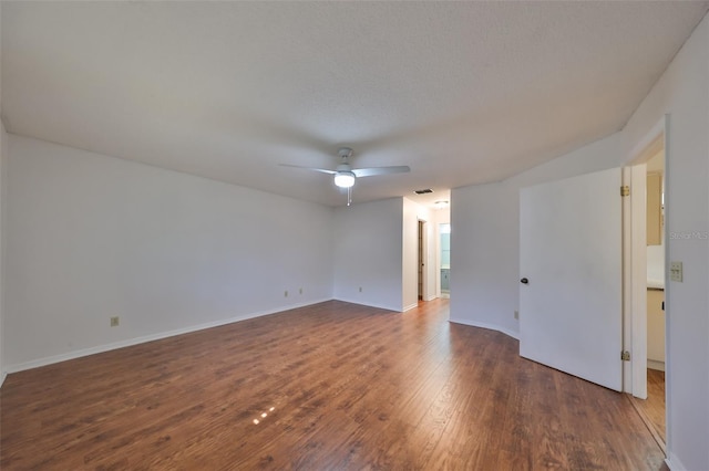 empty room with dark hardwood / wood-style flooring and ceiling fan