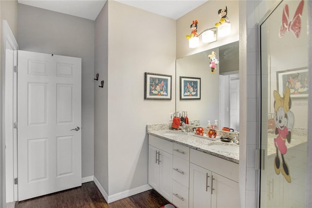 bathroom featuring hardwood / wood-style flooring, vanity, and a shower with door