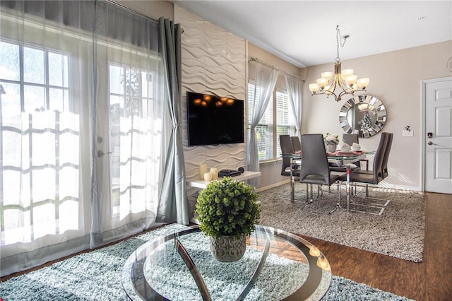 dining space featuring hardwood / wood-style flooring and an inviting chandelier