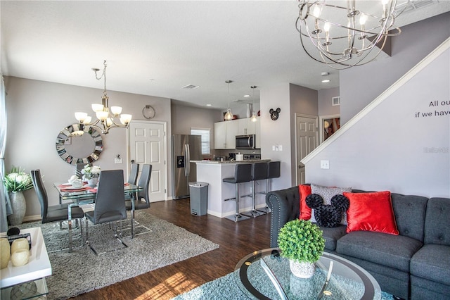 living room featuring a chandelier and dark hardwood / wood-style flooring