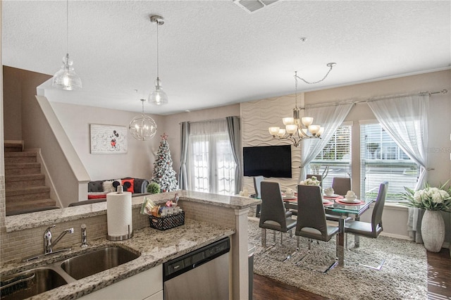 kitchen featuring dishwasher, pendant lighting, and sink