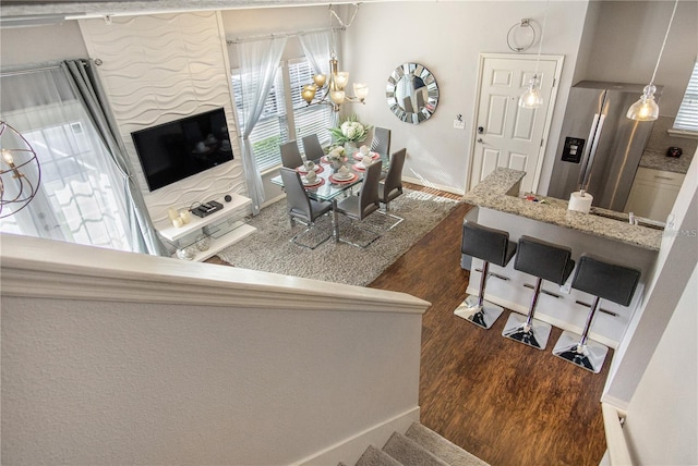 living room featuring dark hardwood / wood-style floors and a notable chandelier