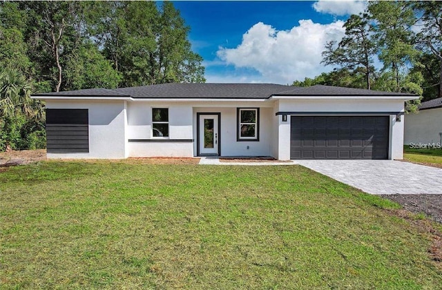 ranch-style home featuring a front lawn and a garage