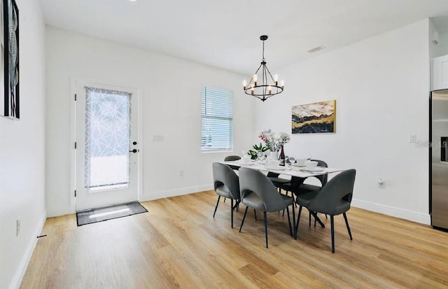 dining space featuring a chandelier and light hardwood / wood-style floors