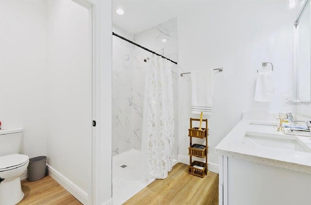 bathroom featuring a shower with curtain, toilet, vanity, and hardwood / wood-style flooring