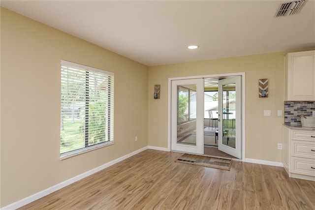 4514 Dewey Dr, New Port Richey, FL 34652 - unfurnished dining area with light wood finished floors, baseboards, and recessed lighting