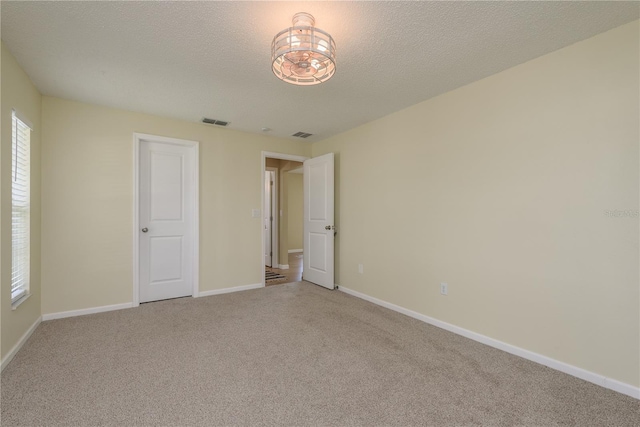 4514 Dewey Dr, New Port Richey, FL 34652 - unfurnished bedroom with carpet, baseboards, and a textured ceiling