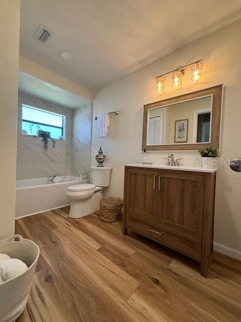 4514 Dewey Dr, New Port Richey, FL 34652 - bathroom with wood finished floors, toilet, and vanity
