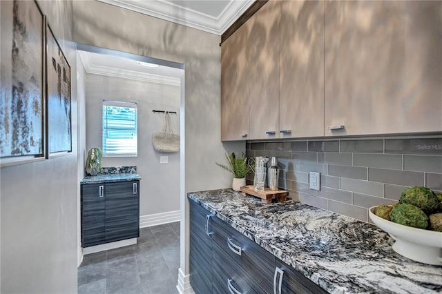 kitchen with ornamental molding, backsplash, and dark stone counters