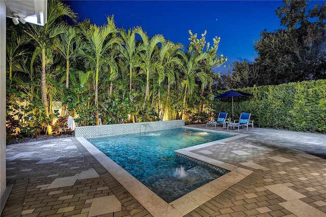 view of swimming pool featuring pool water feature and a patio