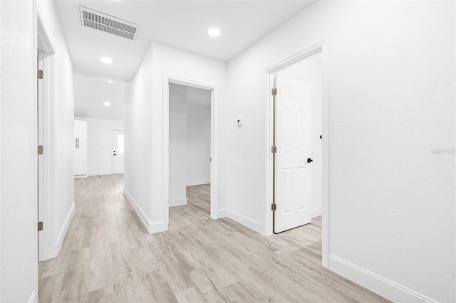 hall with light hardwood / wood-style flooring