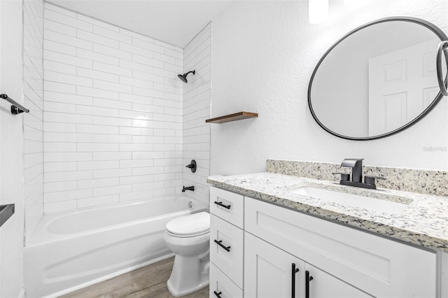 full bathroom featuring vanity, toilet, wood-type flooring, and tiled shower / bath combo