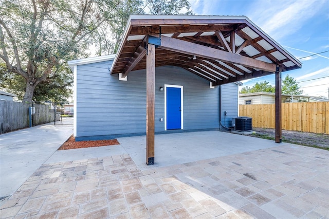 exterior space with a carport and cooling unit