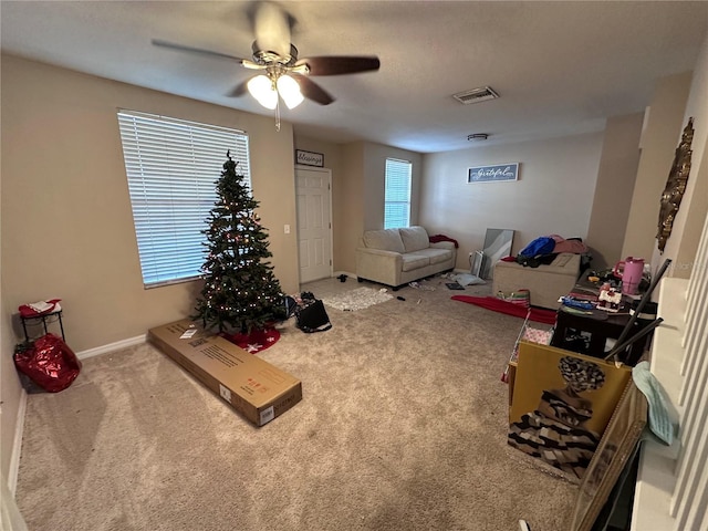 living room featuring ceiling fan and carpet