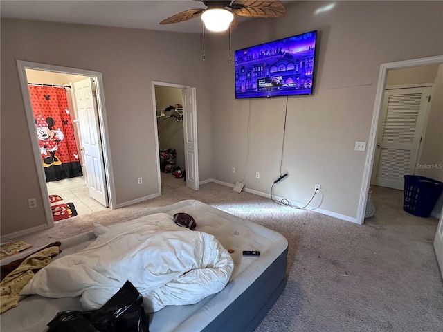 carpeted bedroom featuring a spacious closet, a closet, ceiling fan, and vaulted ceiling