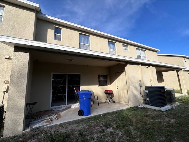 back of house with a patio area and central AC