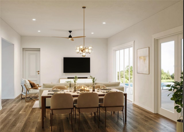 dining space featuring dark hardwood / wood-style floors and ceiling fan with notable chandelier