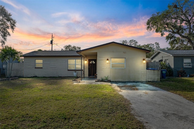 ranch-style home with a yard