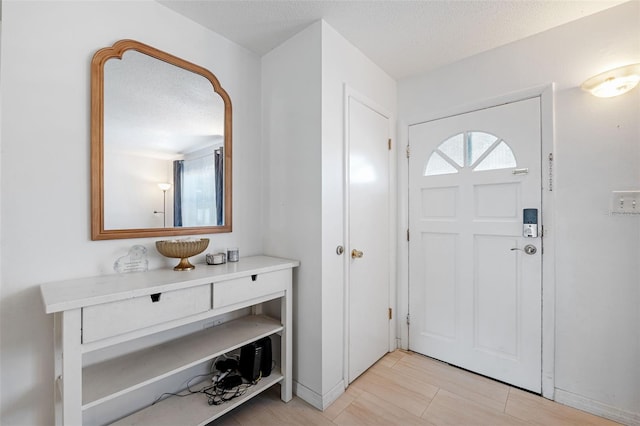 foyer with a textured ceiling