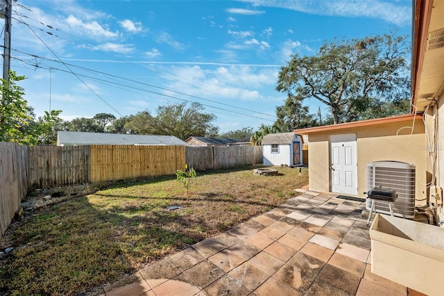 view of yard with a patio, cooling unit, and a storage unit