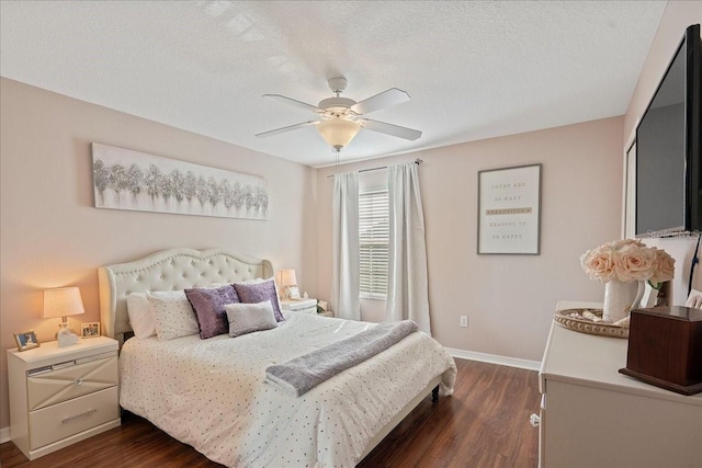 bedroom featuring ceiling fan, dark hardwood / wood-style flooring, and a textured ceiling