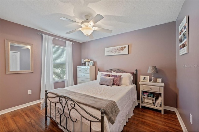 bedroom with ceiling fan, dark hardwood / wood-style flooring, and a textured ceiling