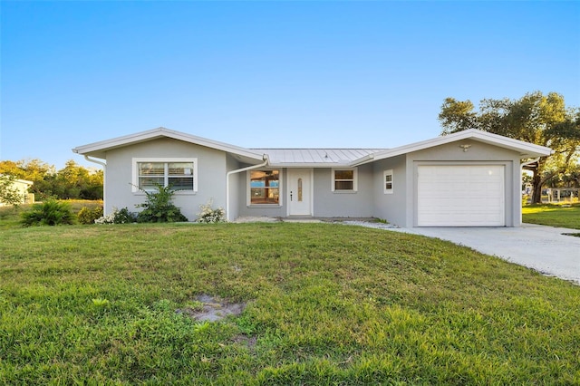 ranch-style house featuring a garage and a front yard