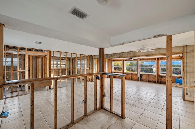 miscellaneous room featuring ceiling fan and tile patterned flooring