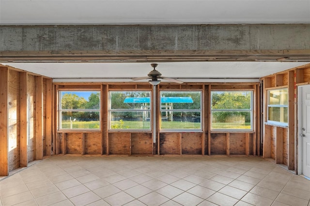 unfurnished sunroom with ceiling fan