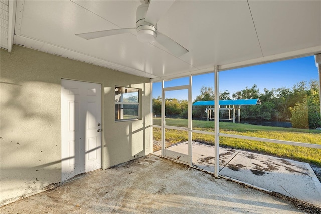 unfurnished sunroom featuring ceiling fan