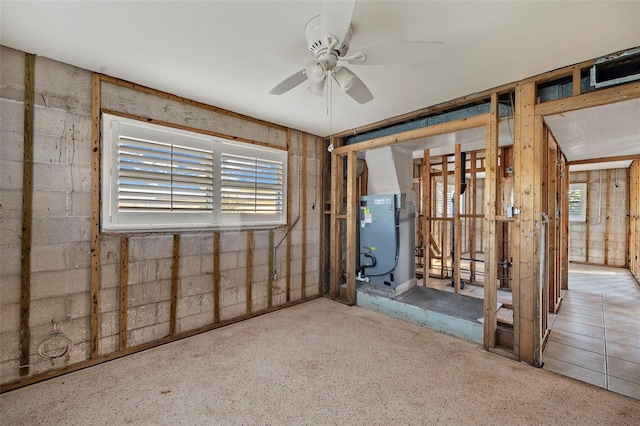 basement featuring heating unit and ceiling fan