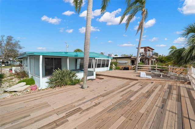 wooden deck with a sunroom