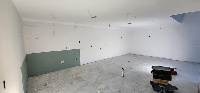 unfurnished room with concrete flooring