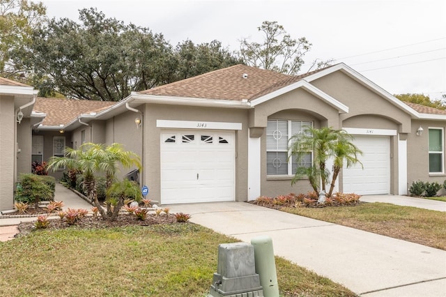 ranch-style house with a front yard and a garage