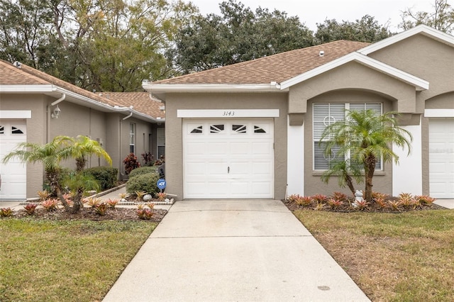 single story home featuring a garage and a front lawn