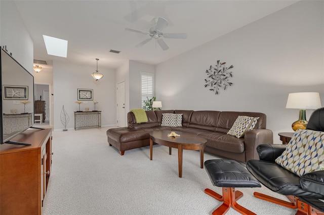 carpeted living room featuring a skylight and ceiling fan