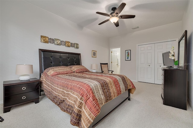 carpeted bedroom featuring ceiling fan and a closet