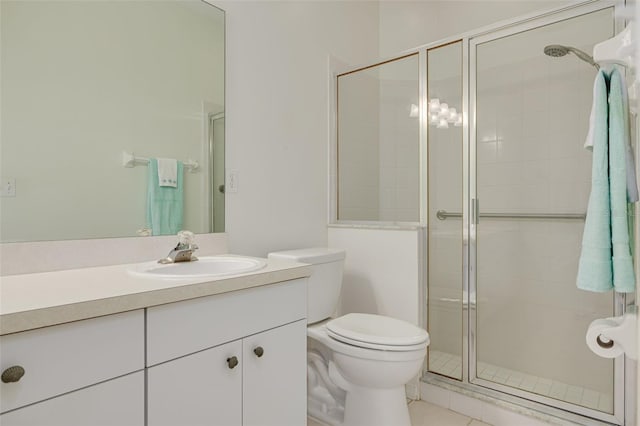 bathroom with vanity, walk in shower, tile patterned floors, and toilet