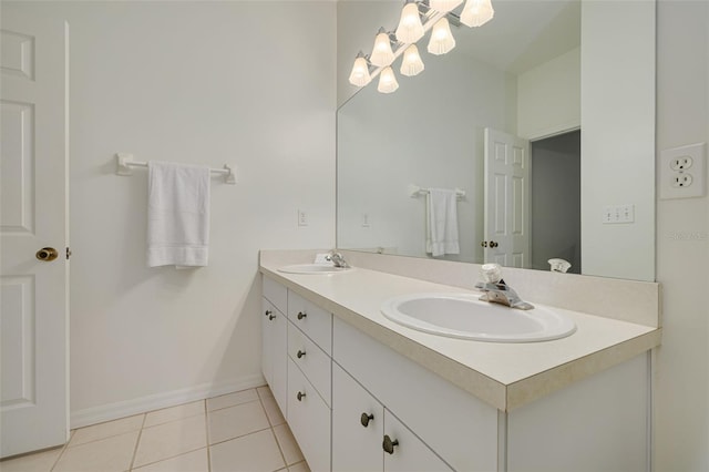 bathroom featuring tile patterned flooring, vanity, and an inviting chandelier