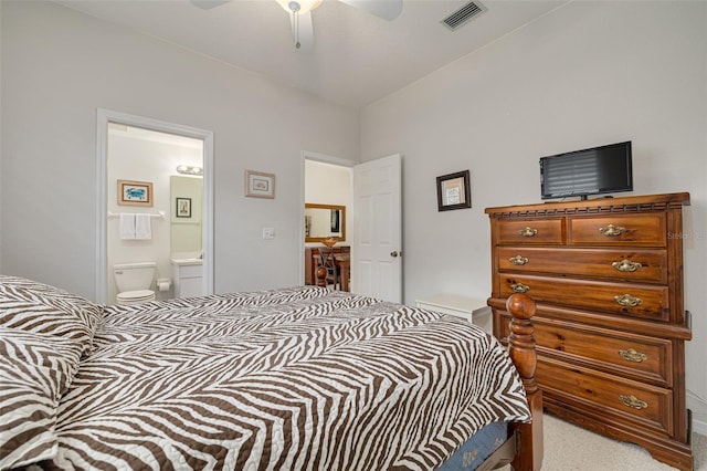 carpeted bedroom featuring connected bathroom and ceiling fan