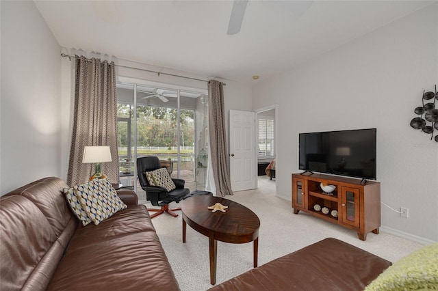 carpeted living room featuring ceiling fan